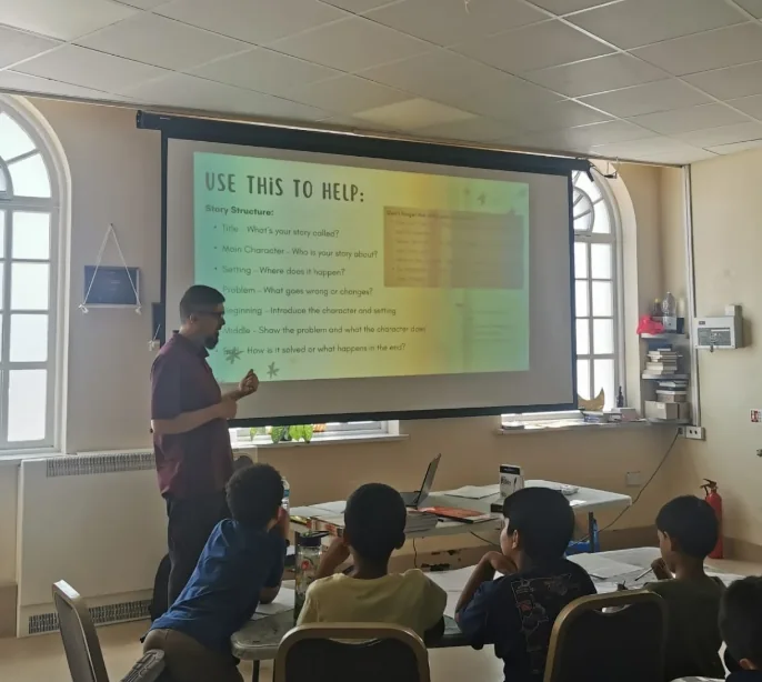 Umair teaching story structure in a creative writing workshop